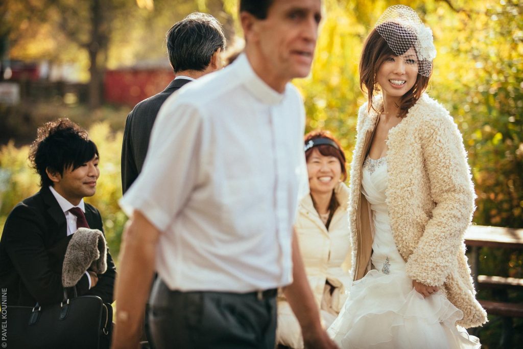 Bride during autumn foliage at St. Andrew's By the Lake Church on Toronto Island