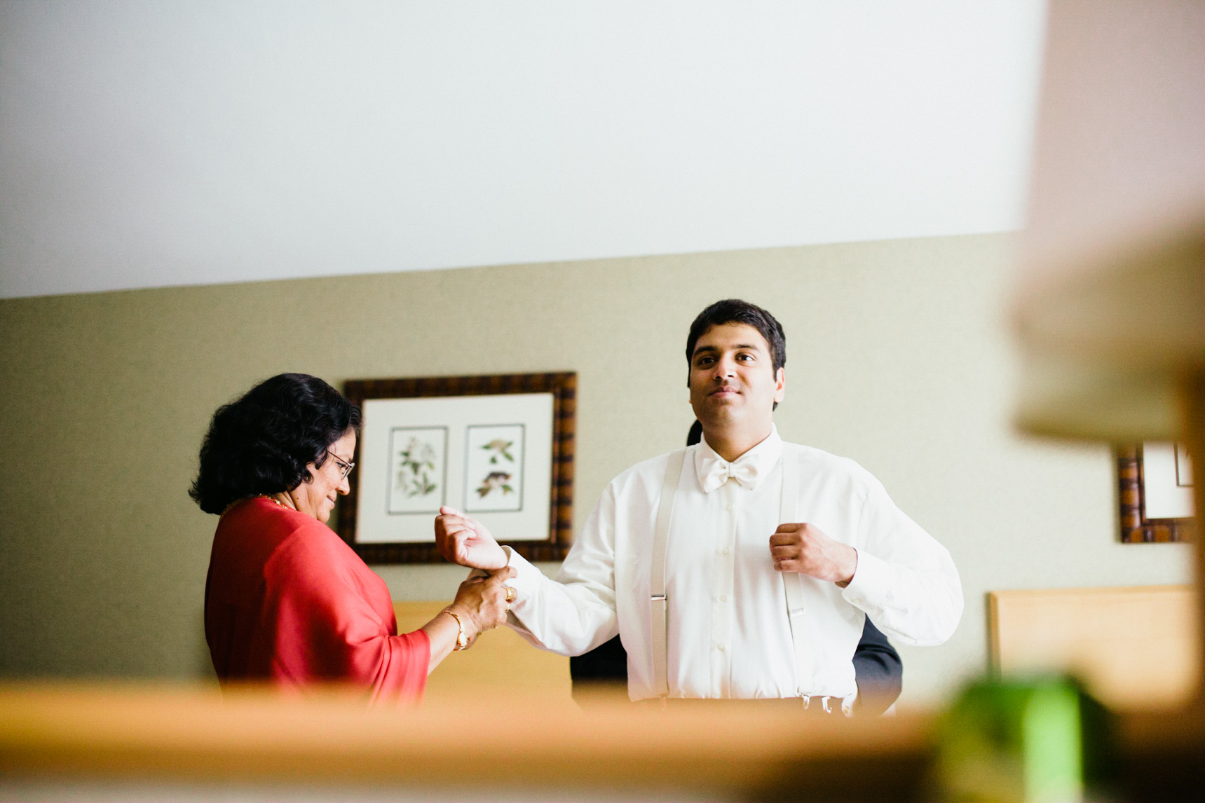 Groom's mother helps with cuff links.