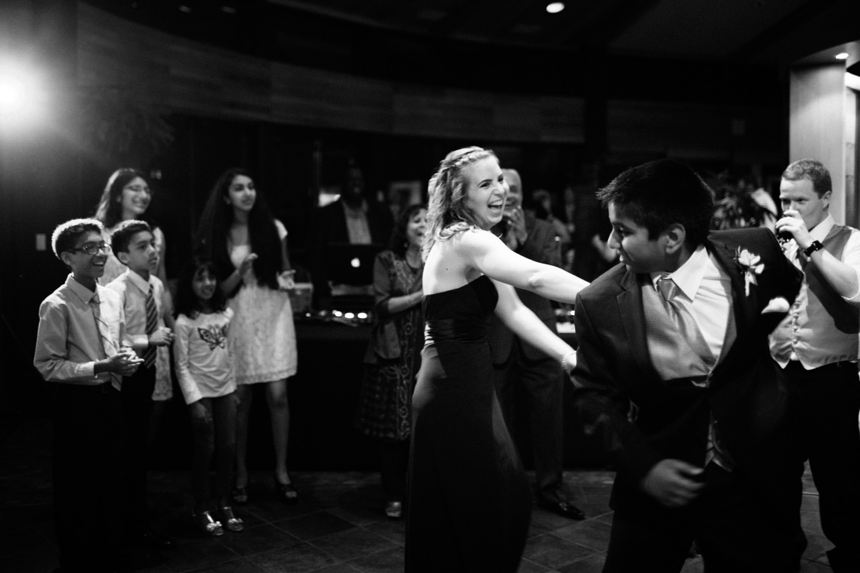 The wedding party dances.