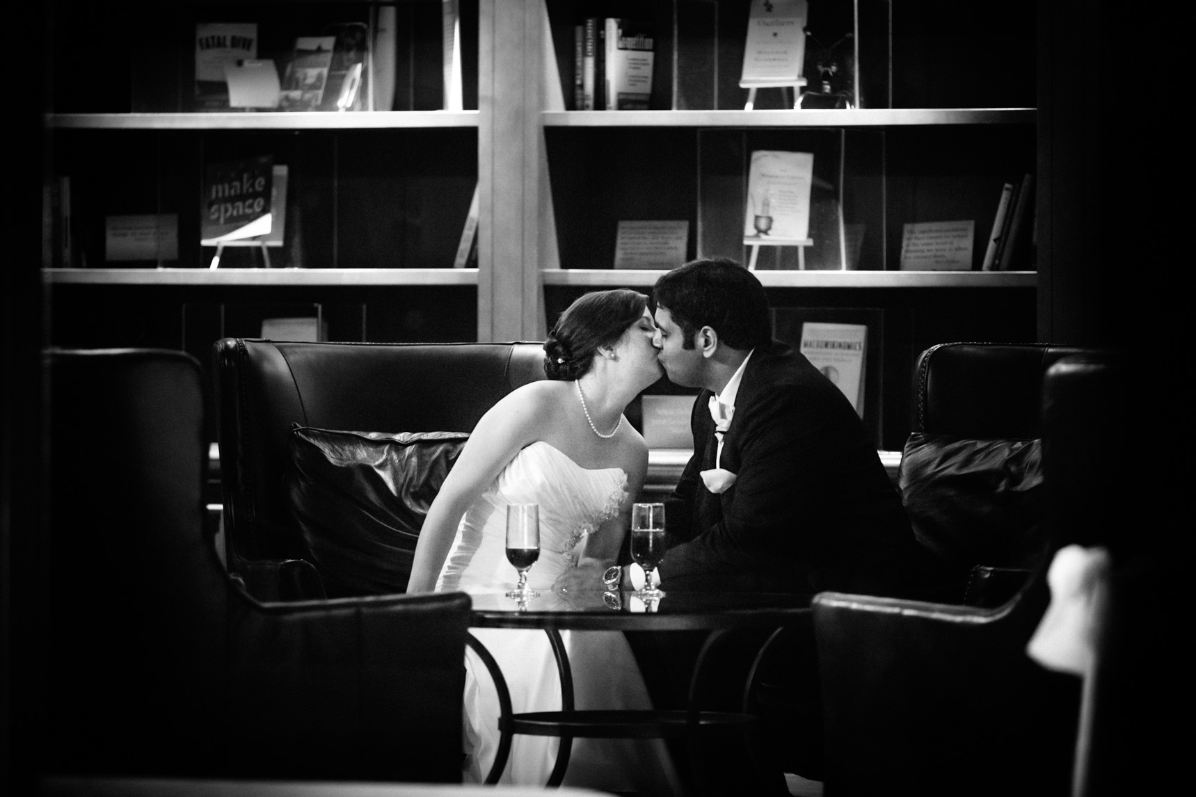 Bride and groom share a kiss during a quiet interlude in the festivities.