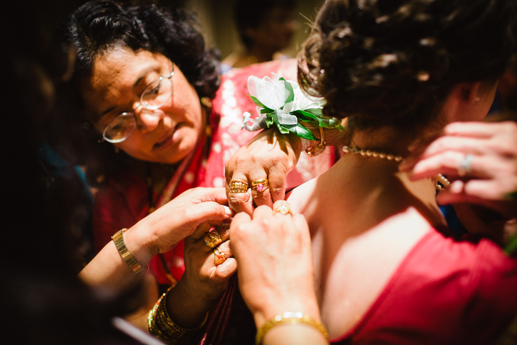 Bride is helped into her evening dress.