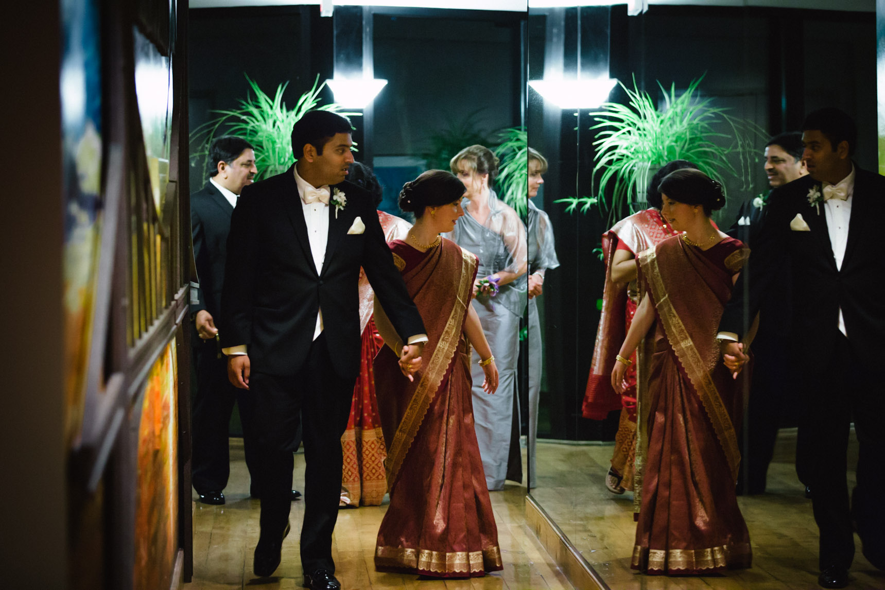 Bride looks at her reflection in mirror. 