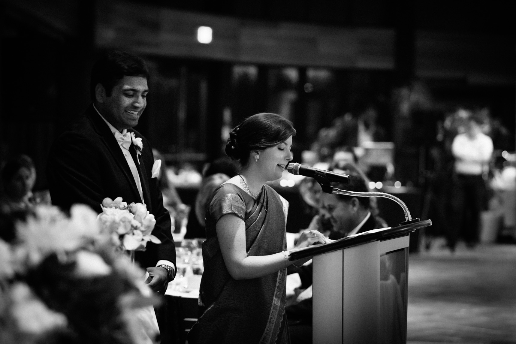 Bride and groom give an evening speech after dinner reception.