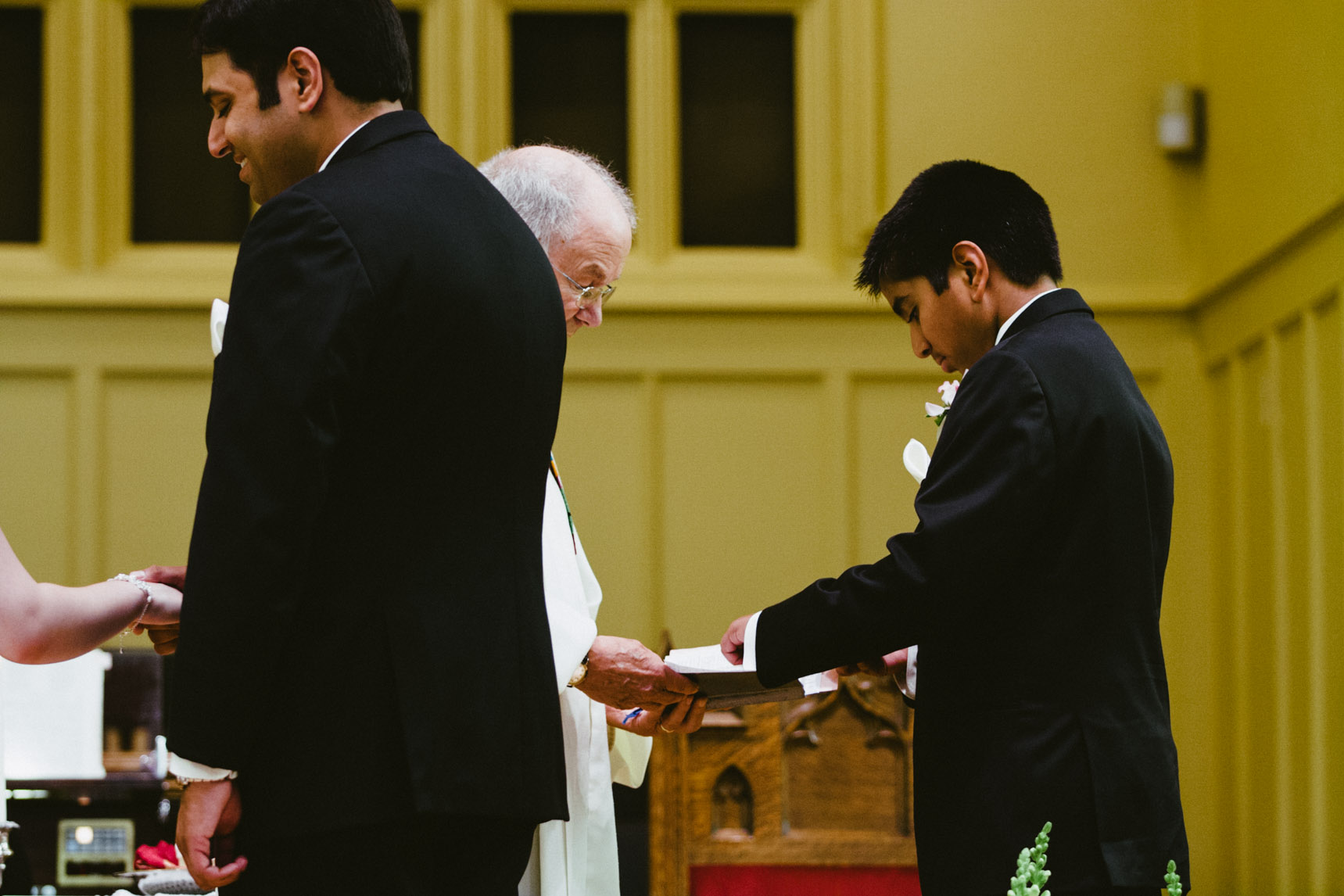 Grooms brother prepares the wedding rings.
