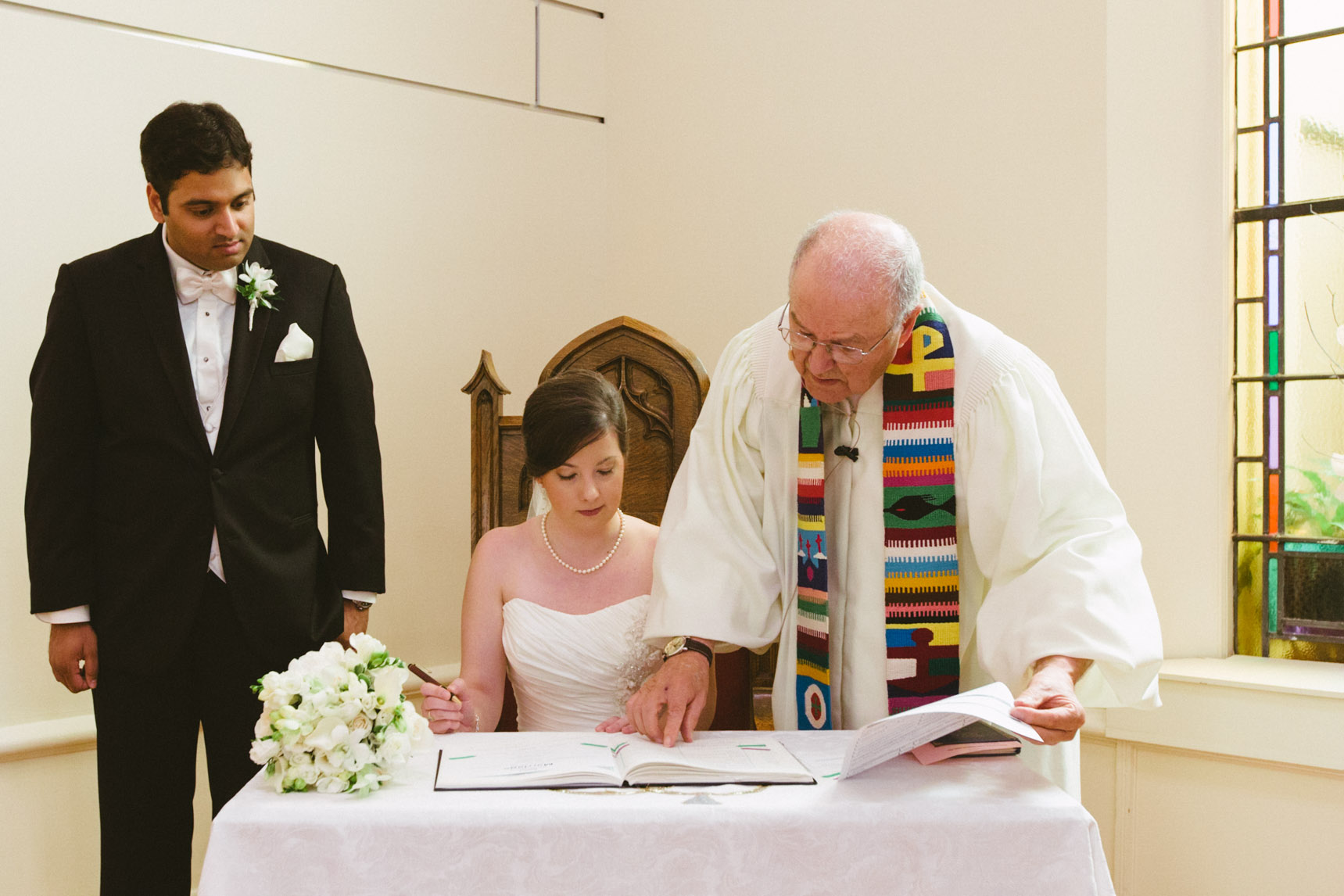 Bride and groom sign the wedding register.