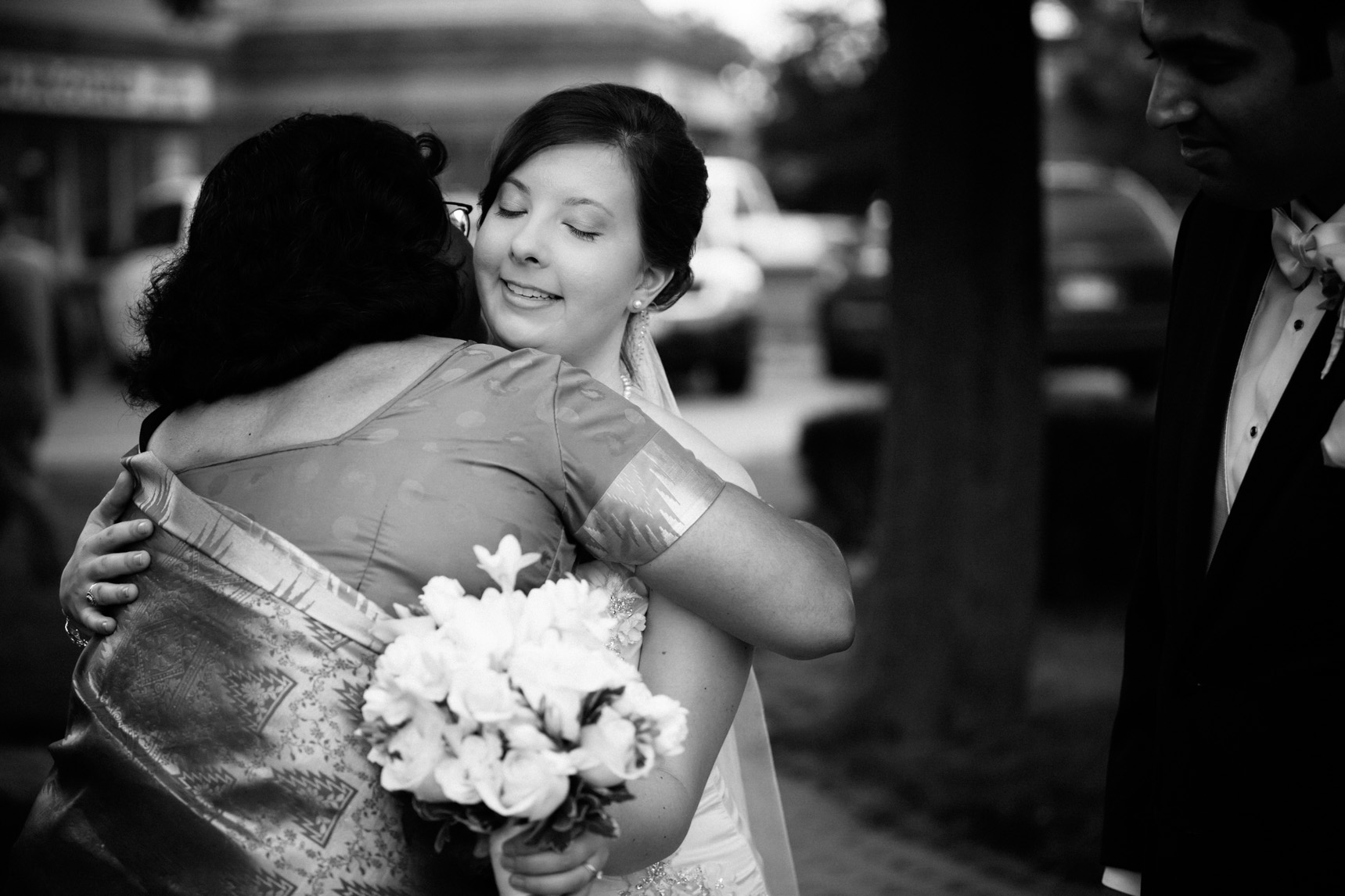 Bride hugs groom's mother after wedding ceremony.