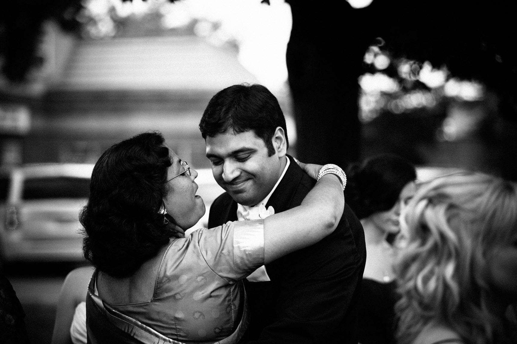 Groom hugs his mother after ceremony.