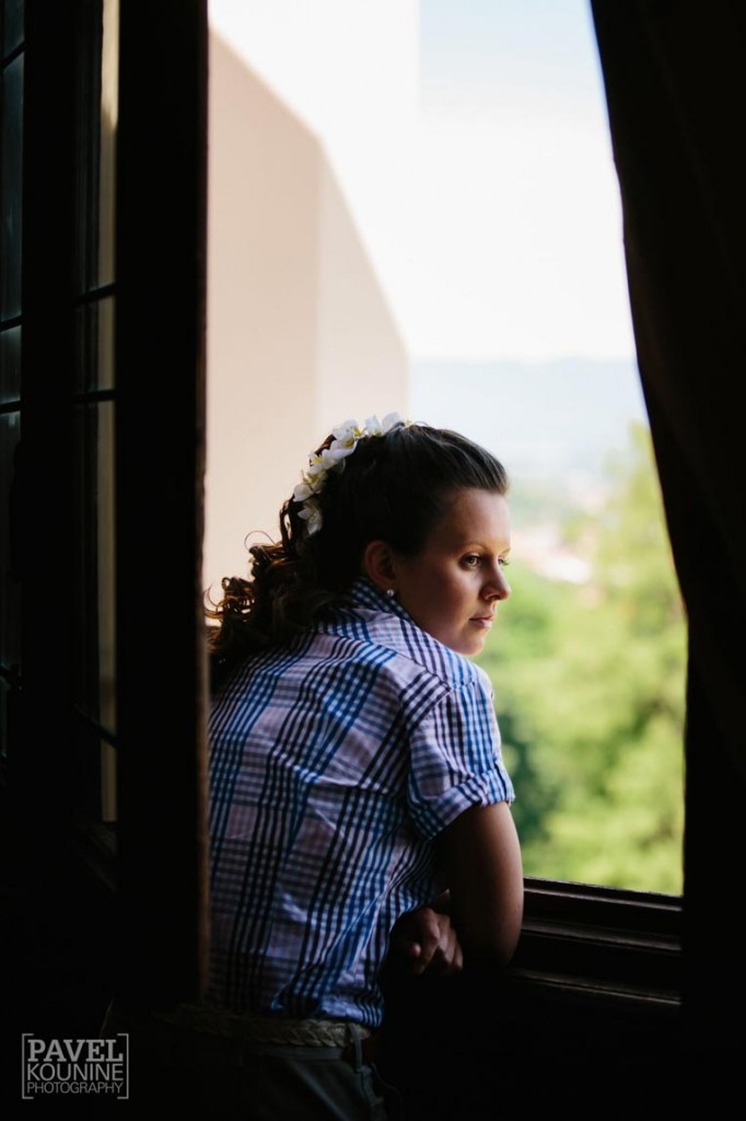 Intimate wedding photography: bride enjoying view of italian countryside from castle
