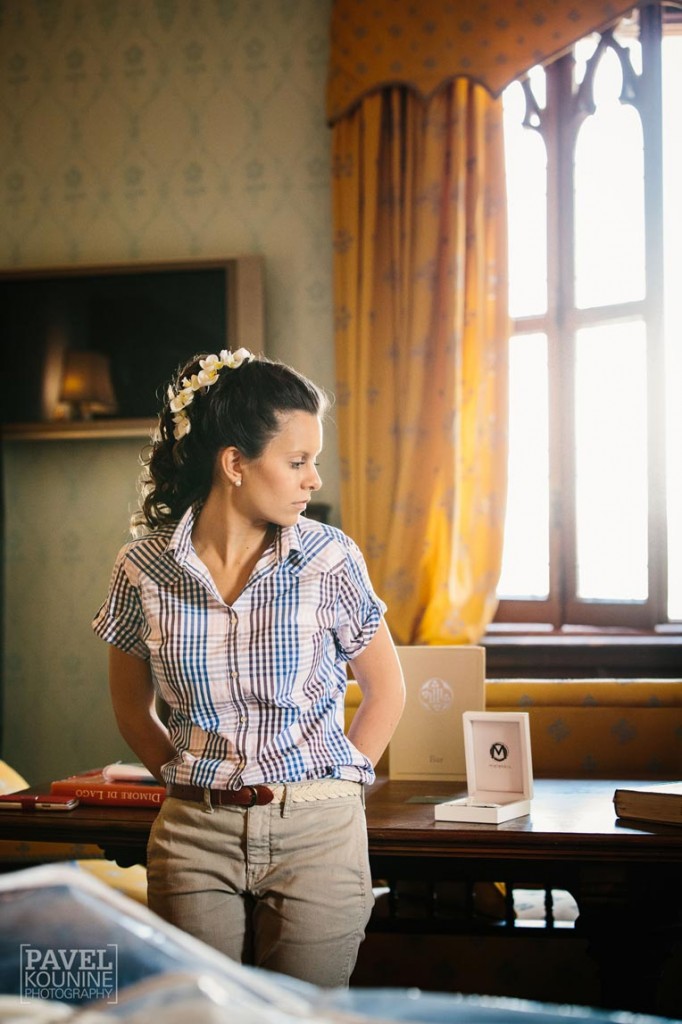 Intimate wedding photography: bride in thought prior to putting dress on