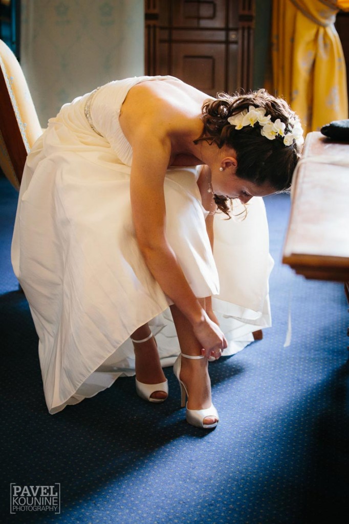 bride adjust straps on her shoes