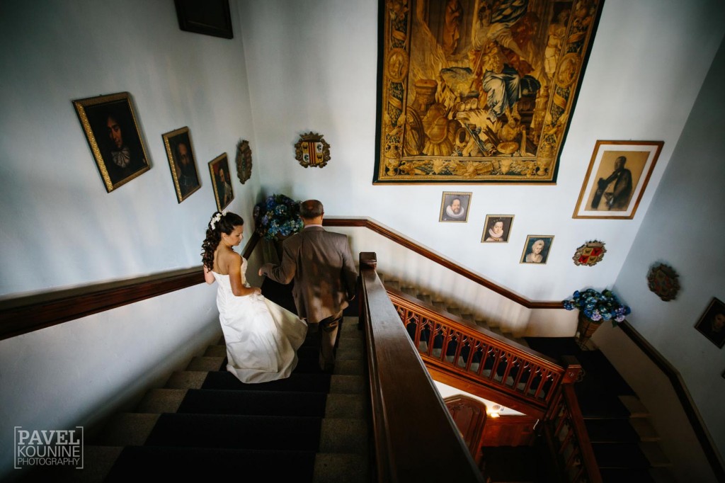 Intimate wedding photography: bride descending castle staircase