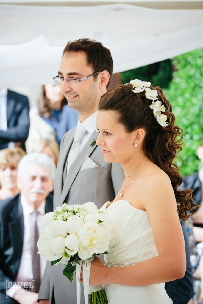Intimate wedding photography: bride smiles at the alter