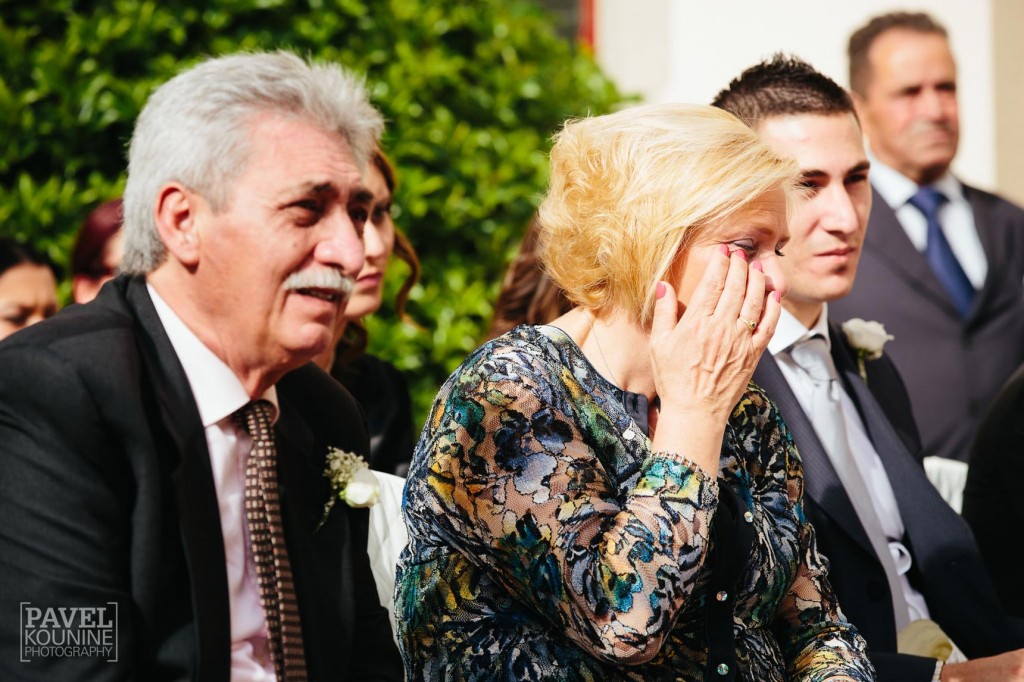 Intimate wedding photography: groom's parents cry