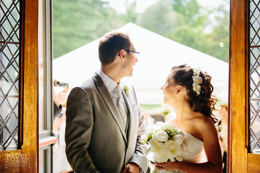Intimate wedding photography: bride and groom laughing after the lengthy ceremony