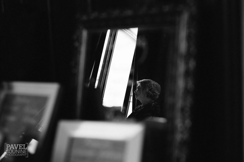 Intimate wedding photography: groom's mother in silhouette