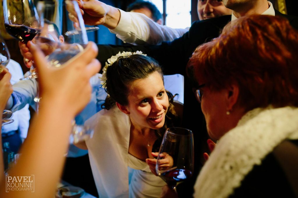 Intimate wedding photography: bride can't believe what's happening during the toast!