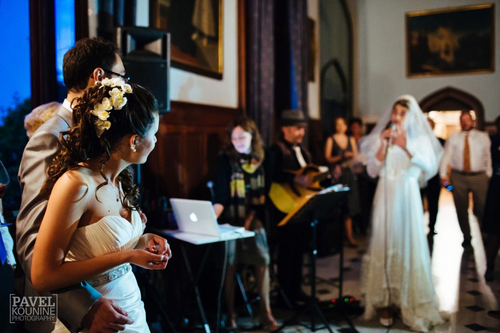 Intimate wedding photography: bride and groom listen to a performance by the anti-bride