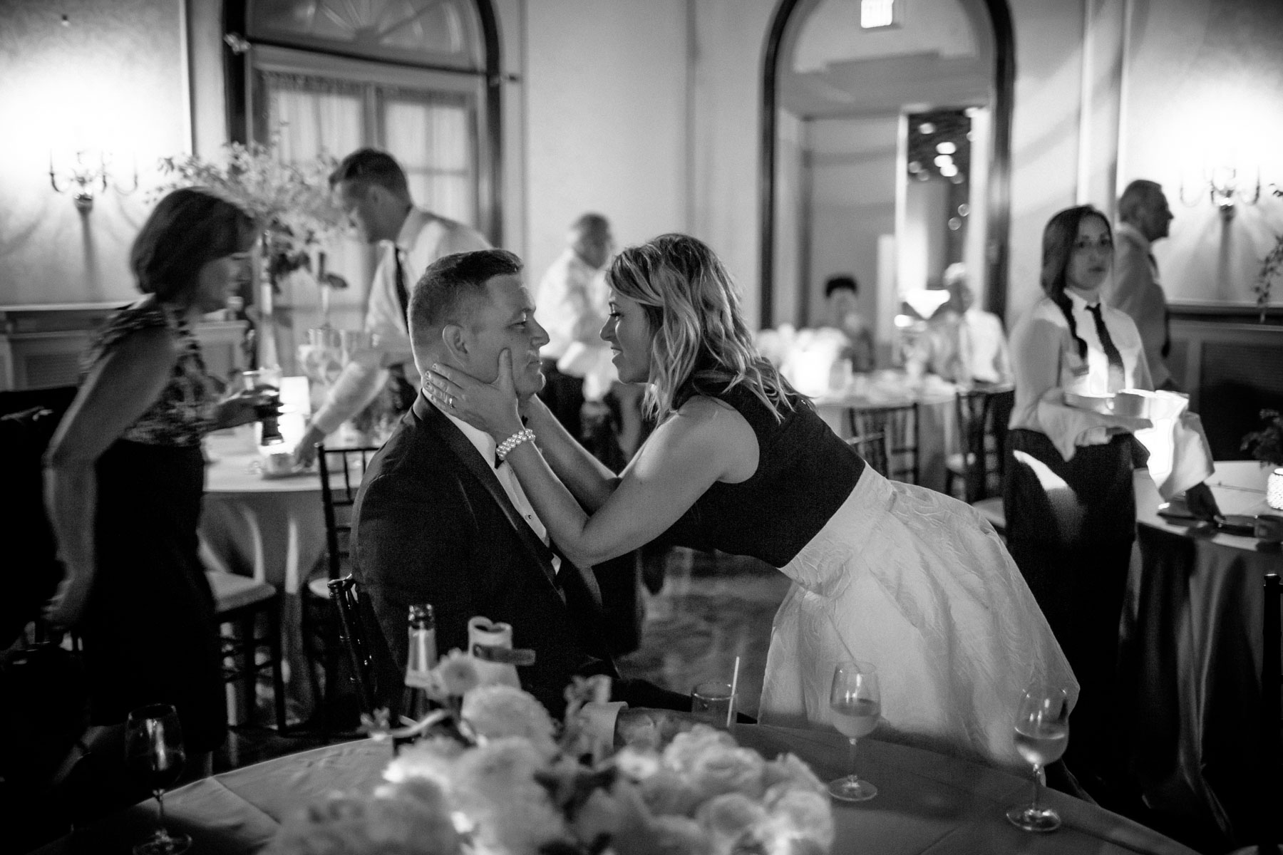 A woman tenderly holds her husband by the cheeks, smiling into his eyes at this Boulevard Club wedding in Toronto.